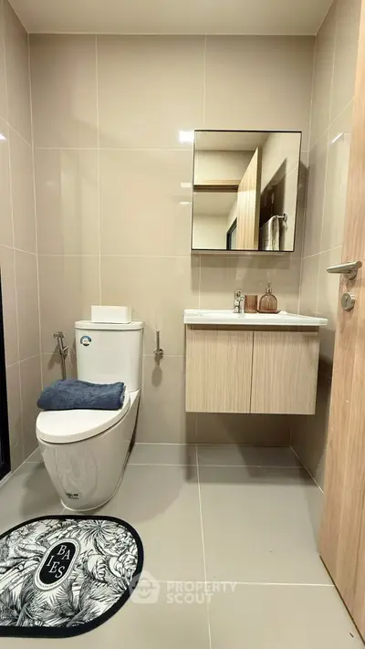 Modern bathroom with sleek fixtures and stylish decor in a contemporary apartment.