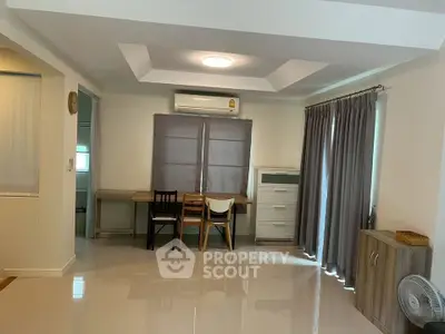 Spacious living room with modern furniture and natural light, perfect for relaxation and entertainment.