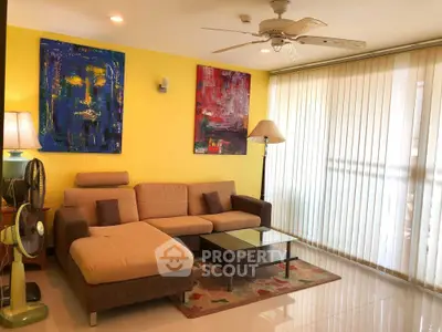 Stylish living room with modern art, cozy sectional sofa, and floor-to-ceiling windows.