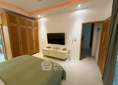 Spacious bedroom with modern decor and built-in wooden wardrobe