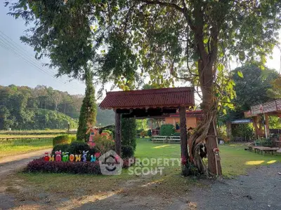 Charming rustic entrance with lush greenery and welcoming sign, perfect for serene countryside living.