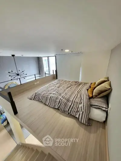 Modern loft bedroom with stylish decor and natural light