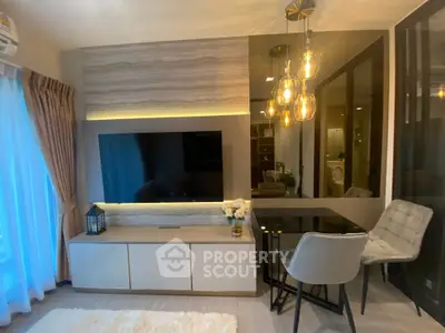 Modern living room with stylish decor and ambient lighting, featuring a sleek TV setup and elegant seating area.