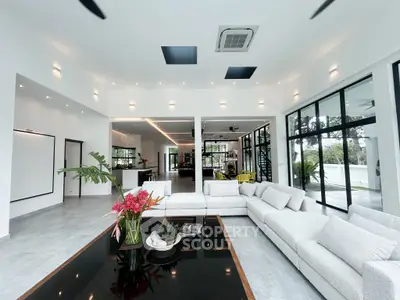 Luxurious modern living room with expansive windows and elegant decor, perfect for sophisticated living.