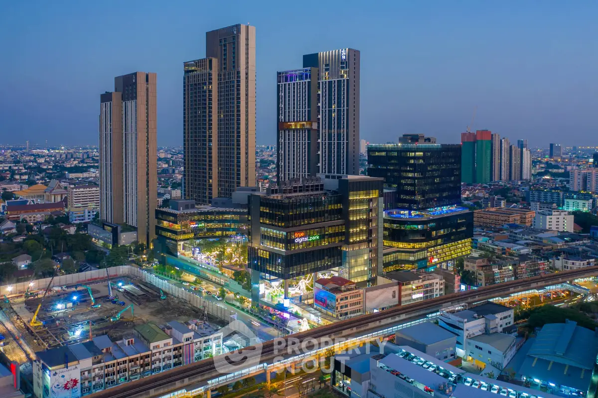 Stunning cityscape view of modern high-rise buildings at dusk with vibrant city lights.
