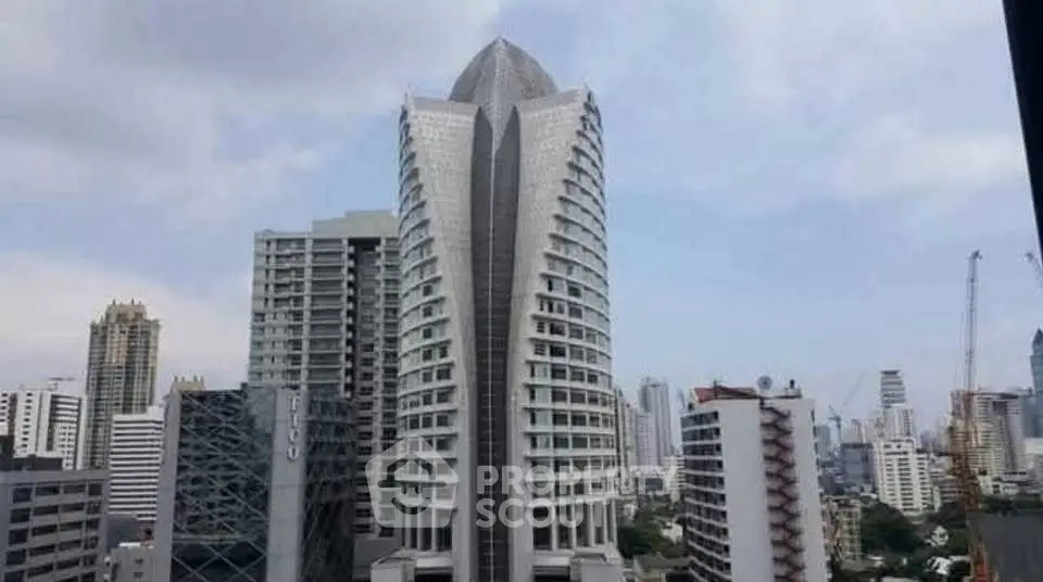 Stunning cityscape view featuring a modern high-rise building with unique architectural design.