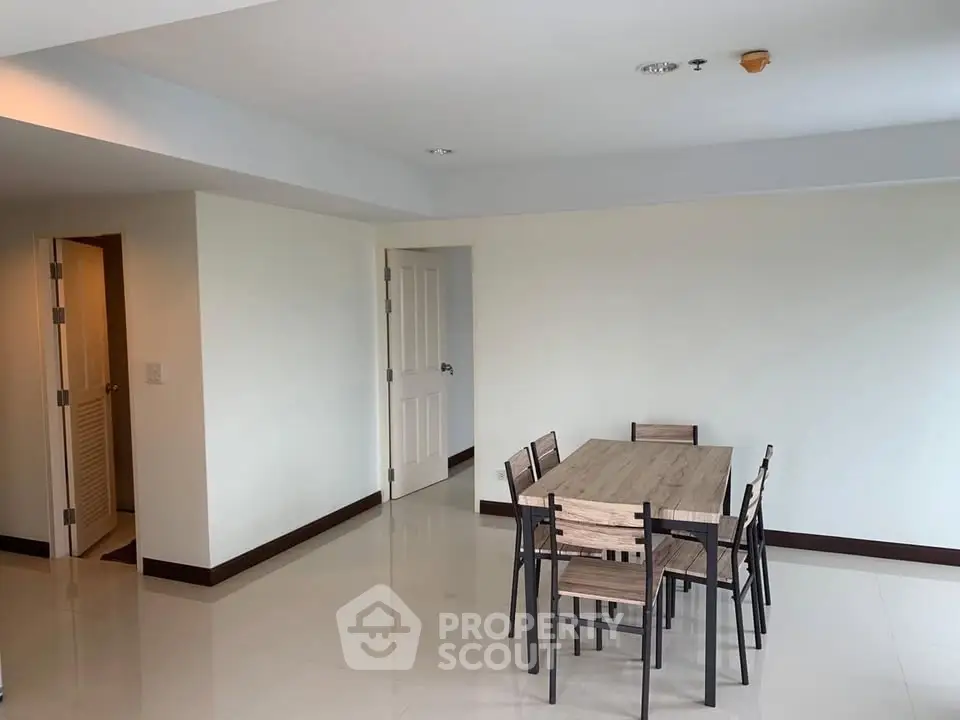 Spacious dining area with modern table and chairs in a bright apartment