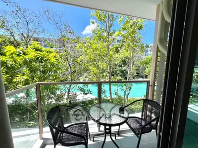 Charming balcony with pool view, perfect for relaxation and enjoying nature's beauty.