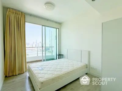 Bright bedroom with large window and city view, featuring a comfortable bed and modern decor.