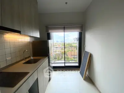 Modern kitchen with balcony view in urban apartment