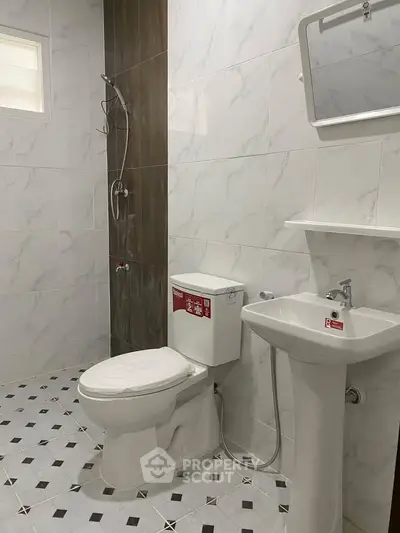 Modern bathroom with sleek fixtures and elegant tile design.