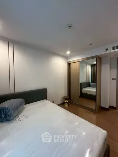 Modern bedroom with mirrored wardrobe and stylish decor