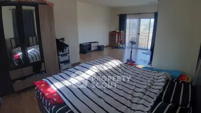 Spacious bedroom with balcony access and natural light