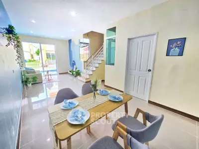 Modern open-plan living and dining area with elegant decor and natural light.
