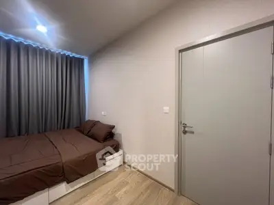 Cozy bedroom with modern design and soft lighting, featuring a comfortable bed and stylish curtains.