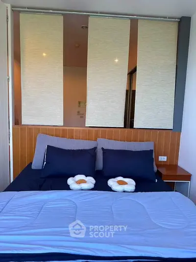 Cozy bedroom with modern decor and stylish bedding in a contemporary apartment.