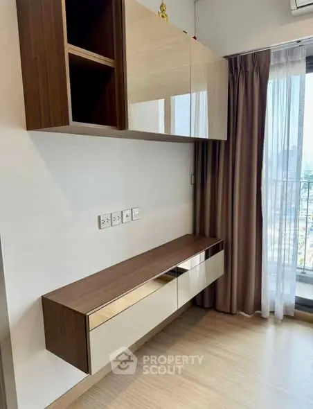 Modern interior with sleek wall cabinets and large window view.