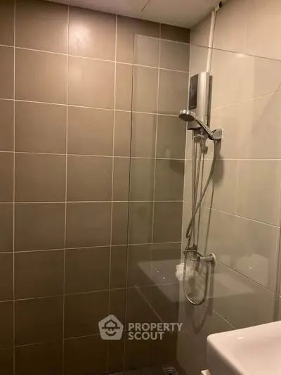 Modern bathroom with sleek shower and neutral tiles