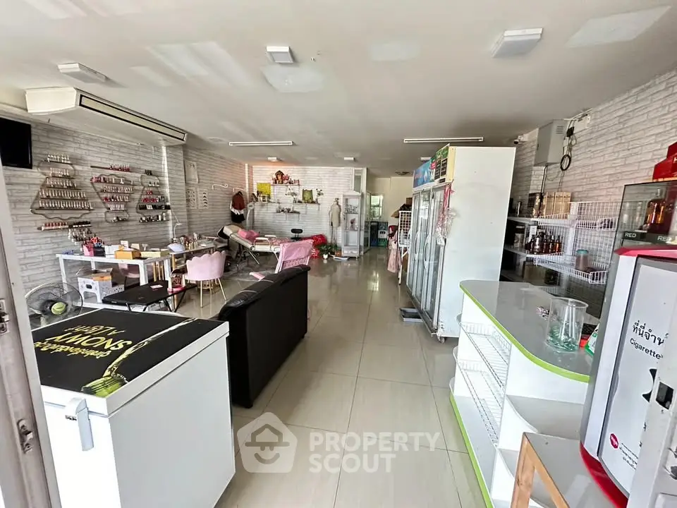 Spacious commercial space with modern interior and ample shelving, ideal for retail or office use.