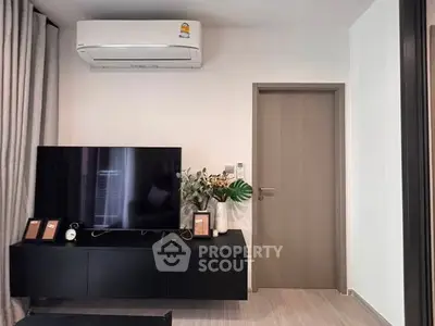 Modern living room with sleek TV unit and air conditioning, perfect for comfortable living.