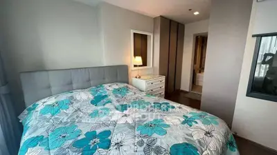 Cozy bedroom with floral bedding and modern decor in a stylish apartment.
