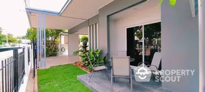 Charming modern patio with lush greenery and outdoor seating area