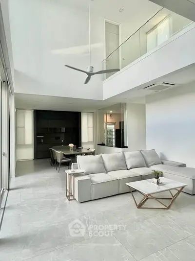 Spacious modern living room with high ceiling and elegant decor