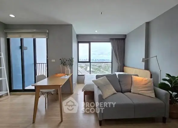 Modern studio apartment with city view and stylish furnishings