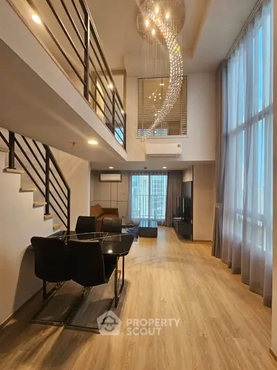 Luxurious duplex living room with high ceilings and modern chandelier