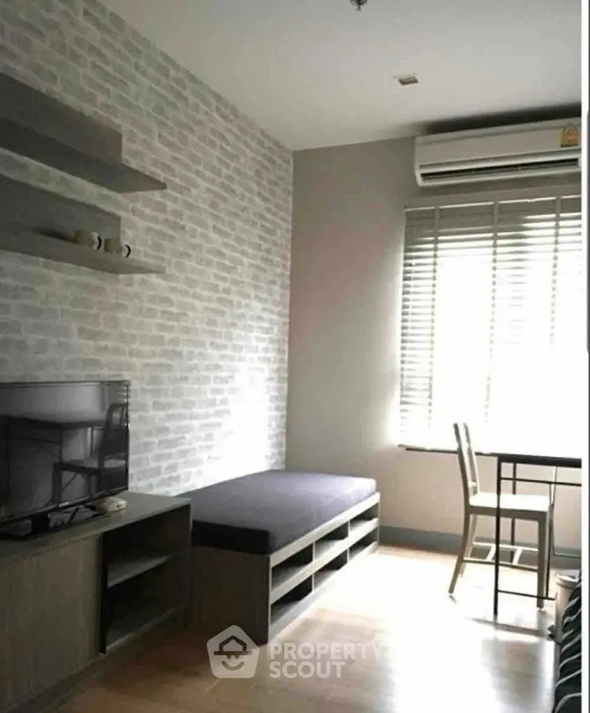 Modern living room with brick accent wall and sleek furniture