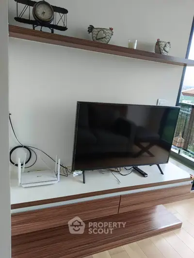 Modern living room with sleek TV setup and stylish wooden shelves
