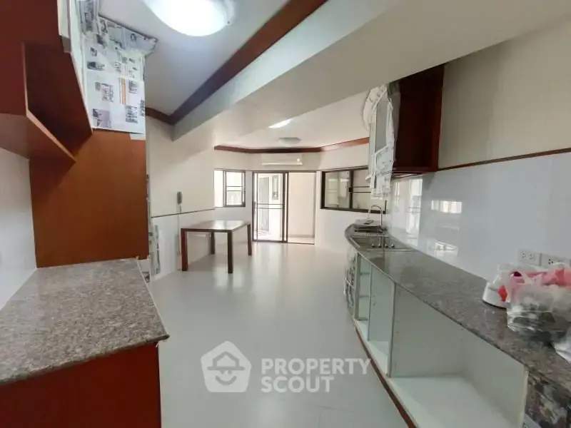 Spacious kitchen with open layout and modern countertops in a bright apartment.