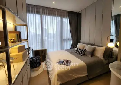 Modern bedroom with cozy decor and large window view