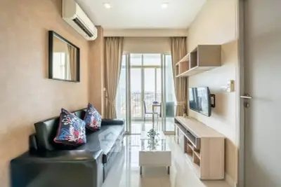 Modern living room with sleek furniture and balcony view in a stylish apartment.