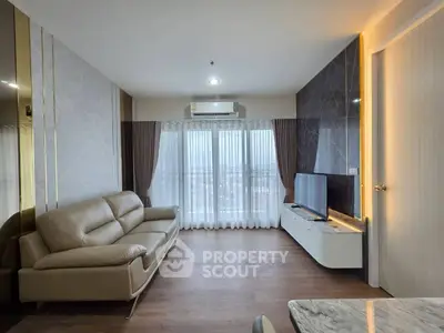 Modern living room with sleek design, featuring a leather sofa, wall-mounted TV, and large window with city view.