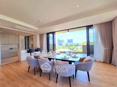 Luxurious open-plan living room with dining area and stunning city view, featuring elegant decor and ample natural light.