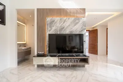 Luxurious modern living room with marble flooring and sleek TV setup