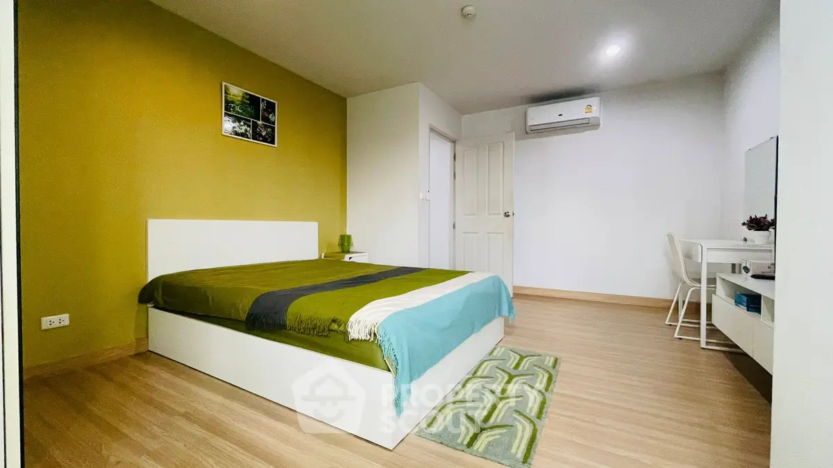 Modern bedroom with stylish decor and air conditioning in a cozy apartment.