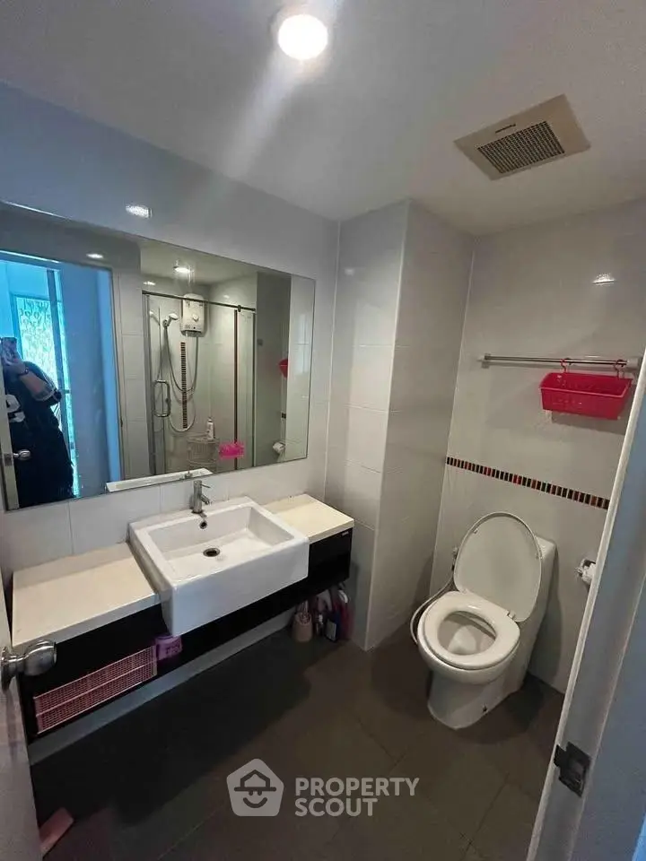 Modern bathroom with sleek fixtures and spacious shower area