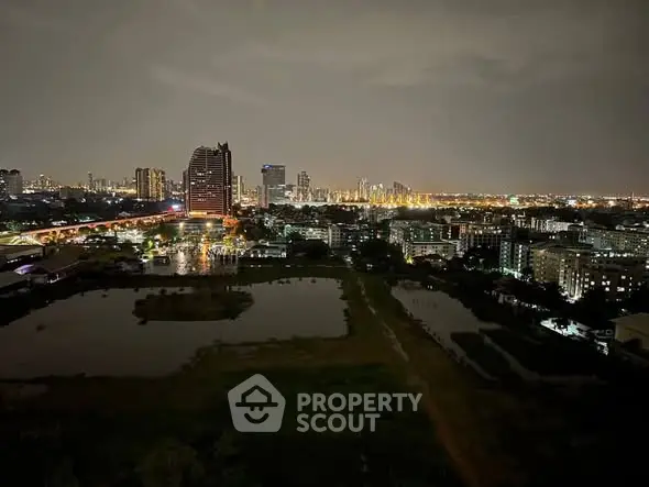 Stunning cityscape view from high-rise building at night with illuminated skyline.