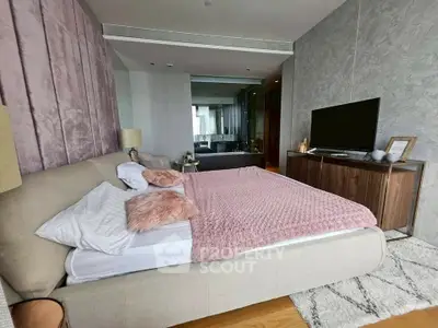 Luxurious bedroom with plush bedding and modern decor in upscale apartment.
