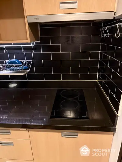 Modern kitchen with sleek black countertops and electric stove