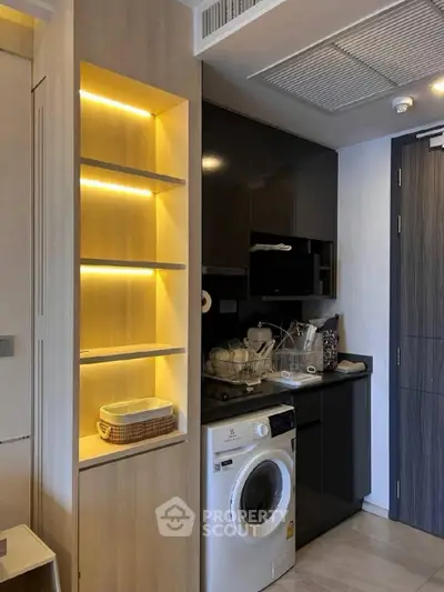 Modern compact kitchen with washing machine and illuminated shelving