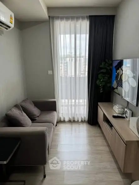 Cozy living room with modern decor and large window view