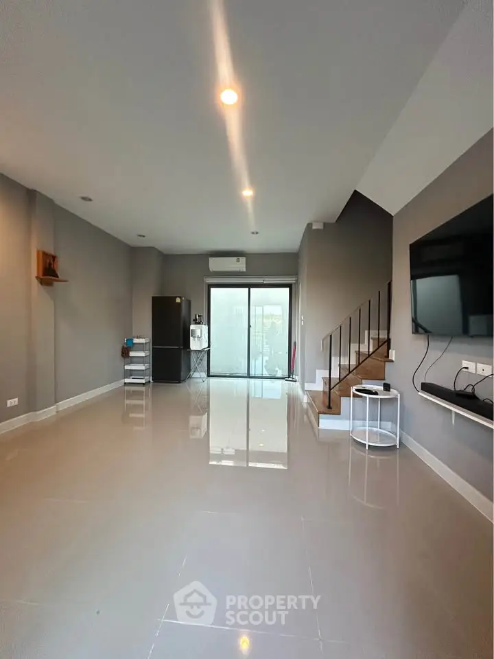 Spacious modern living room with sleek design and large windows for natural light.