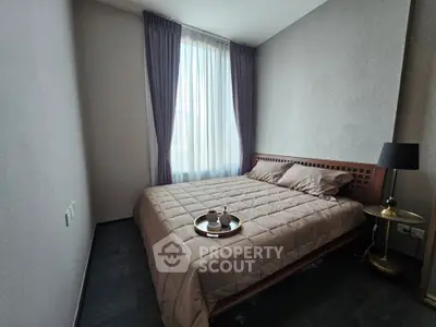 Cozy bedroom with elegant decor and natural light, perfect for relaxation.