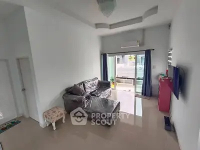 Spacious living room with modern decor and large windows for natural light.