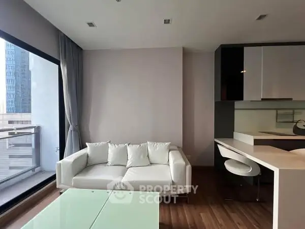 Modern living room with sleek furniture and large window view