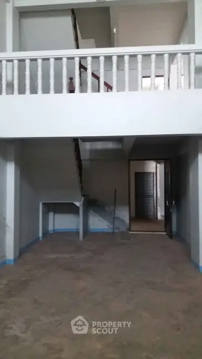 Spacious two-story interior with open staircase and high ceilings