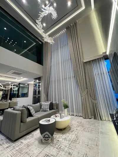 Luxurious modern living room with high ceilings and elegant decor